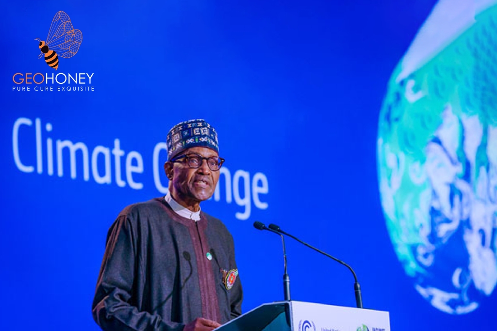 A Nigerian politician, Samuel Onuigbo, standing behind a podium and speaking into a microphone. Behind him is a banner with the words "Climate Change Act 2021" in green and white.